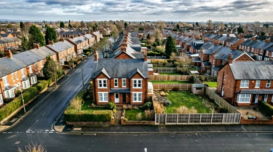 Aerial wide-angle view of a residential property with development potential showing roofline and surrounding context