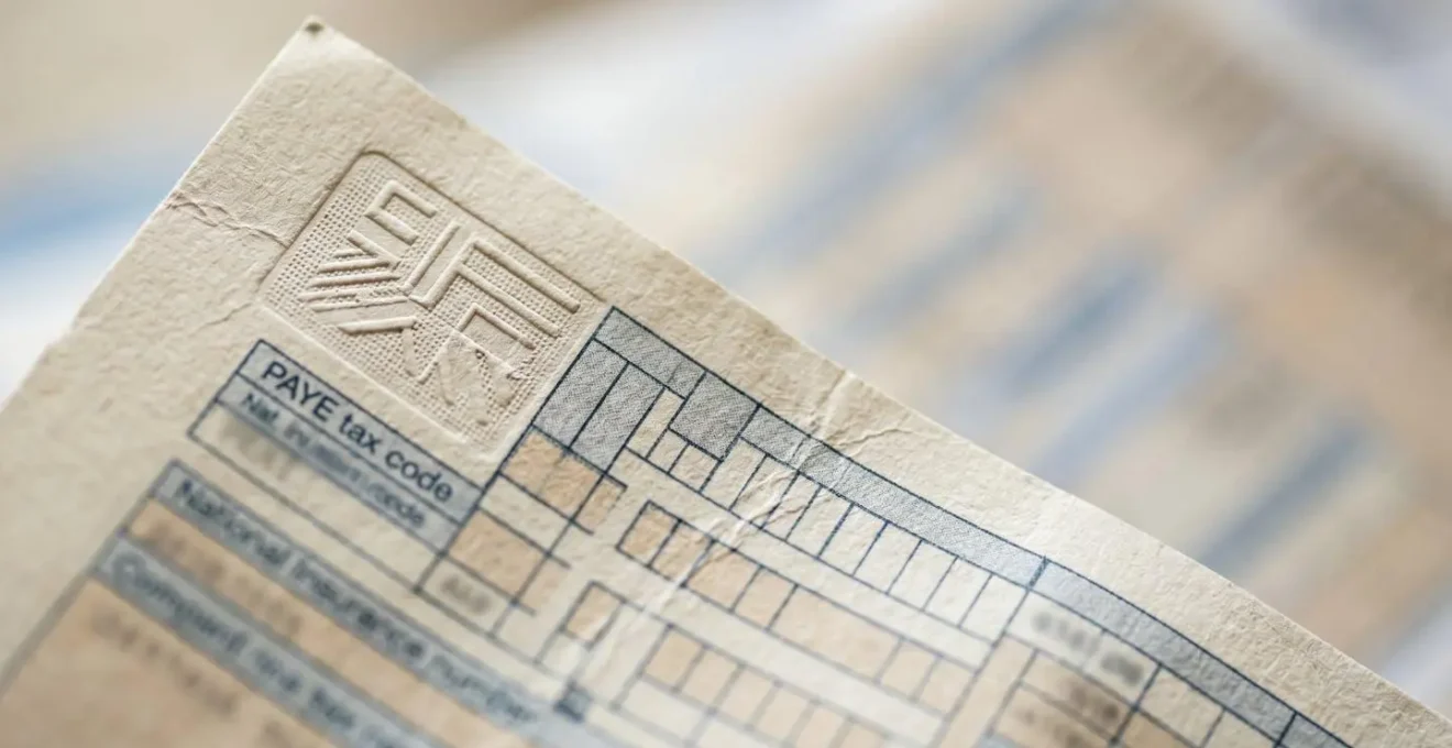 Close-up examination of UK payslip showing key verification elements for landlord screening
